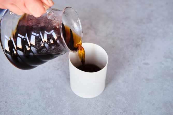servindo o café pelo vidro da V60 em uma xícara